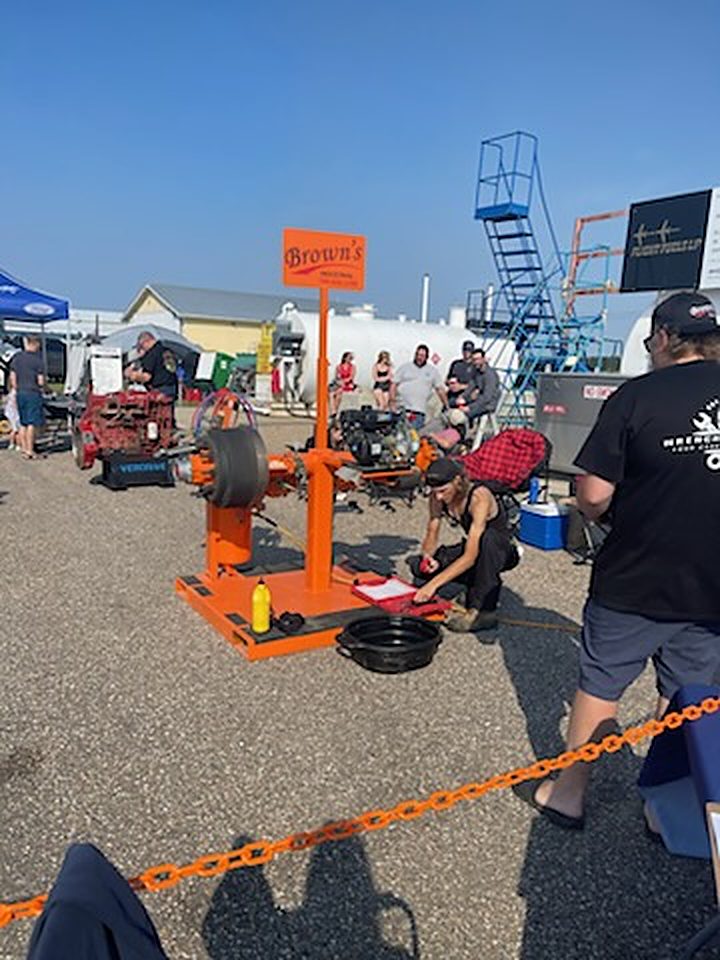A contestant working on the orange brake stand while judges look on